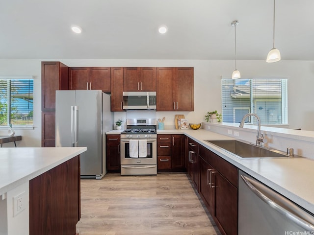 91-1512 Ulaula Loop, Ewa Beach, HI 96706 - kitchen with appliances with stainless steel finishes, light countertops, decorative light fixtures, light wood-style flooring, and recessed lighting