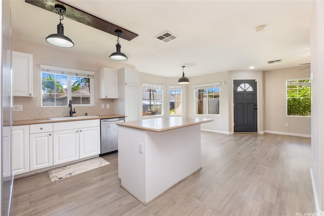 91-2070 Kaioli St Unit 4404, Ewa Beach, HI 96706 - kitchen with dishwasher, light wood-style floors, and white cabinets