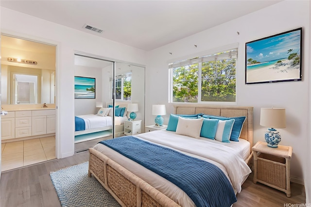 91-2070 Kaioli St Unit 4404, Ewa Beach, HI 96706 - bedroom featuring light wood-style flooring, a closet, and ensuite bath