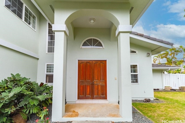 46-145 Humu Pl, Kaneohe, HI 96744 - view of exterior entry featuring stucco siding and a yard