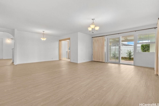 46-145 Humu Pl, Kaneohe, HI 96744 - unfurnished room featuring a chandelier, light wood finished floors, and arched walkways