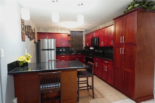94-49 Waipahu St Unit 314, Waipahu, HI 96797 - kitchen featuring stainless steel appliances, dark brown cabinets, dark countertops, a peninsula, and tasteful backsplash