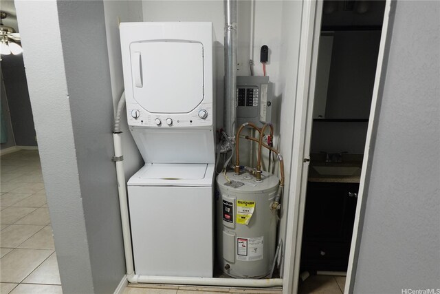 94-49 Waipahu St Unit 314, Waipahu, HI 96797 - laundry room with stacked washer and clothes dryer, water heater, and light tile patterned floors