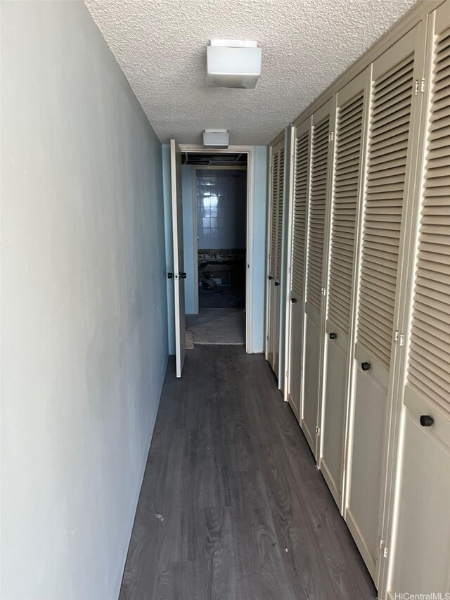 1650 Ala Moana Blvd Unit 2309, Honolulu, HI 96815 - hallway featuring a textured ceiling and dark wood finished floors