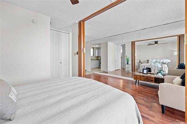 1561 Pensacola St Unit 1104, Honolulu, HI 96822 - bedroom featuring wood finished floors, a textured ceiling, and a ceiling fan