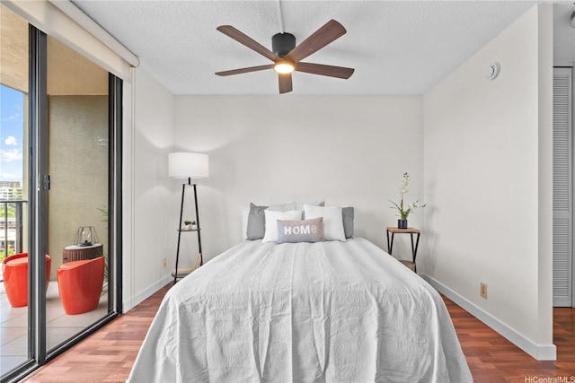 1561 Pensacola St Unit 1104, Honolulu, HI 96822 - bedroom with wood finished floors, a textured ceiling, and a ceiling fan