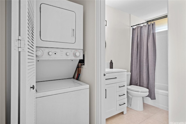 1561 Pensacola St Unit 1104, Honolulu, HI 96822 - washroom featuring estacked washer and dryer and light tile patterned floors