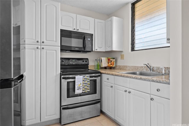 1561 Pensacola St Unit 1104, Honolulu, HI 96822 - kitchen featuring stainless steel appliances, white cabinets, light tile patterned flooring, a textured ceiling, and light countertops