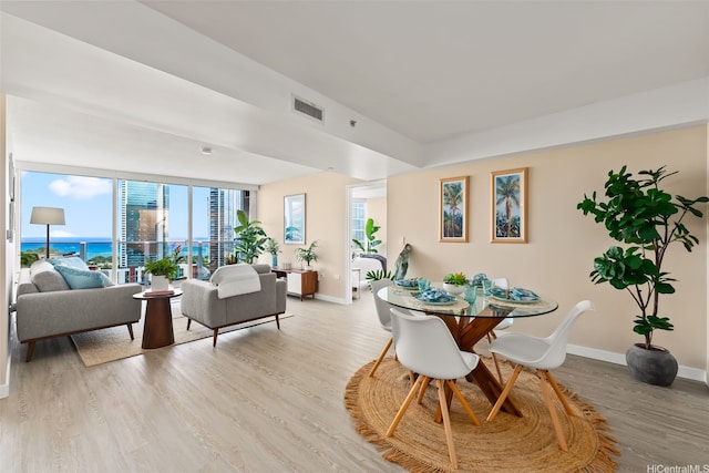 1296 Kapiolani Blvd Unit Ii2407, Honolulu, HI 96814 - dining space featuring light wood finished floors and a water view