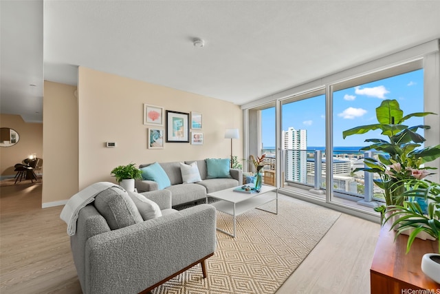 1296 Kapiolani Blvd Unit Ii2407, Honolulu, HI 96814 - living area featuring light wood-style flooring, floor to ceiling windows, healthy amount of natural light, and a water view