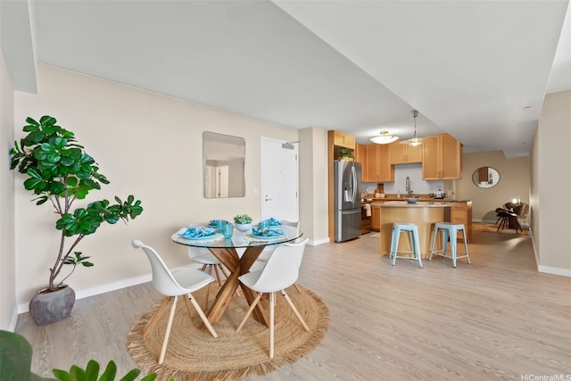1296 Kapiolani Blvd Unit Ii2407, Honolulu, HI 96814 - dining space featuring light wood-style flooring and baseboards