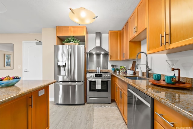 1296 Kapiolani Blvd Unit Ii2407, Honolulu, HI 96814 - kitchen featuring stainless steel appliances, wall chimney exhaust hood, light wood finished floors, and light stone countertops