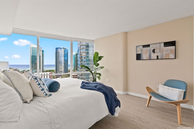 1296 Kapiolani Blvd Unit Ii2407, Honolulu, HI 96814 - bedroom with wood finished floors, a wall of windows, and a water view