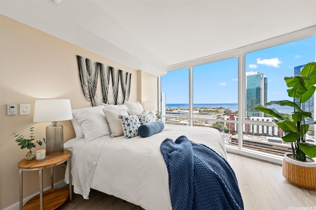 1296 Kapiolani Blvd Unit Ii2407, Honolulu, HI 96814 - bedroom featuring wood finished floors, a water view, and floor to ceiling windows