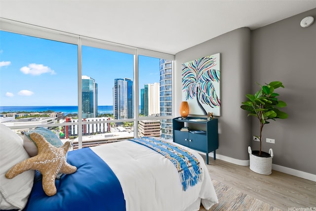 1296 Kapiolani Blvd Unit Ii2407, Honolulu, HI 96814 - bedroom featuring floor to ceiling windows, wood finished floors, a water view, and a city view