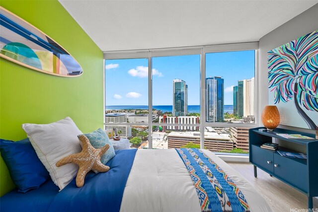 1296 Kapiolani Blvd Unit Ii2407, Honolulu, HI 96814 - bedroom featuring floor to ceiling windows, wood finished floors, a water view, and a view of city