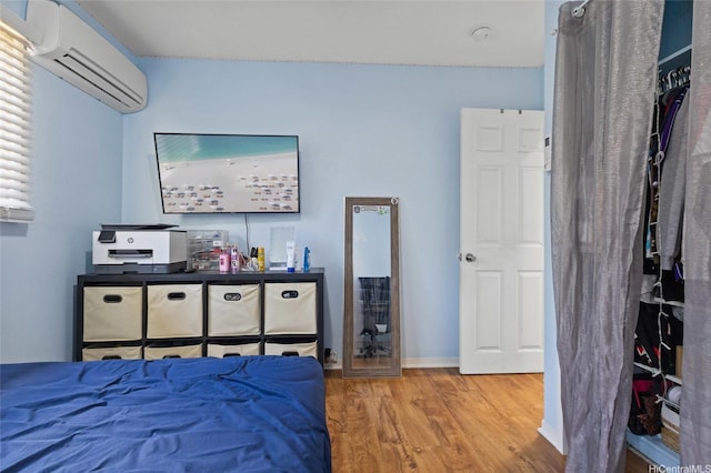 94-555 Awamoi St, Waipahu, HI 96797 - bedroom with a wall mounted air conditioner and wood finished floors