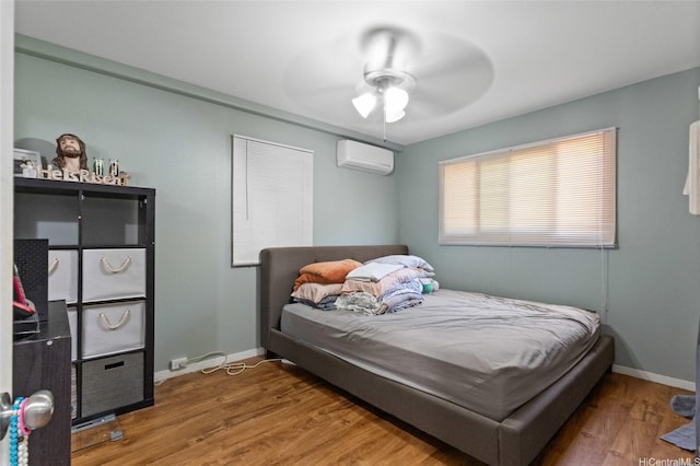 94-555 Awamoi St, Waipahu, HI 96797 - bedroom featuring a wall mounted air conditioner, wood finished floors, and ceiling fan