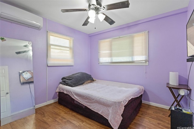 94-555 Awamoi St, Waipahu, HI 96797 - bedroom featuring a wall mounted air conditioner, wood finished floors, and a ceiling fan