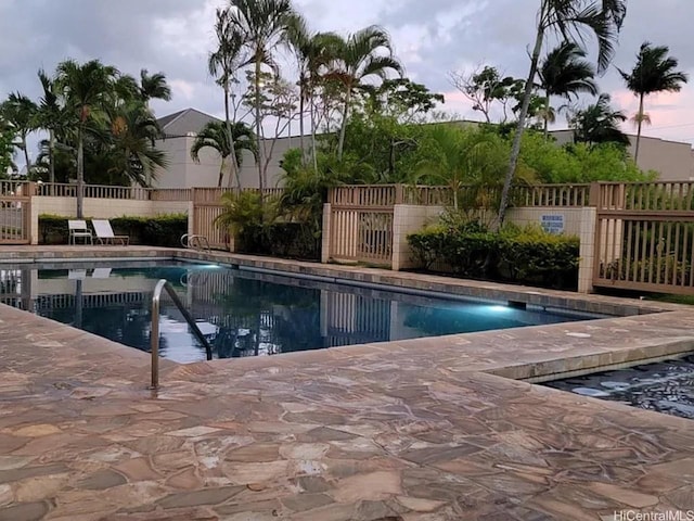 1060 Kamehameha Hwy Unit 302B, Pearl City, HI 96782 - pool at dusk featuring a community pool and a patio