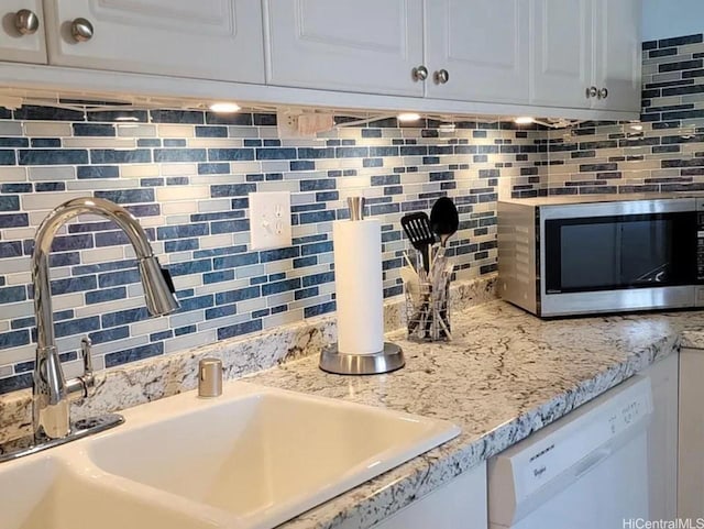 1060 Kamehameha Hwy Unit 302B, Pearl City, HI 96782 - kitchen view of stainless steel microwave, white dishwasher, and tasteful backsplash