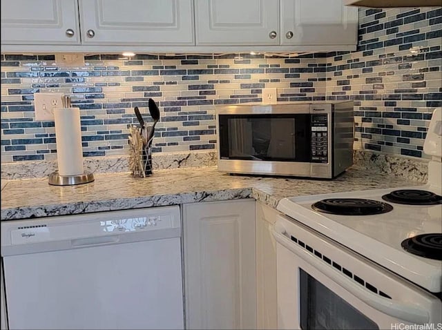 1060 Kamehameha Hwy Unit 302B, Pearl City, HI 96782 - kitchen with white appliances, decorative backsplash, white cabinets, and light stone counters