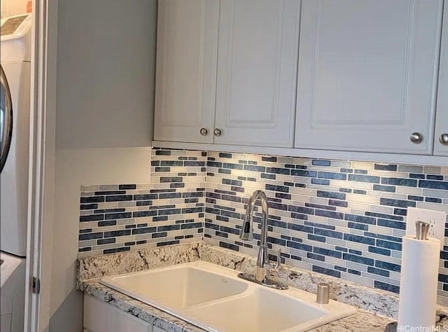 1060 Kamehameha Hwy Unit 302B, Pearl City, HI 96782 - detailed view of tasteful backsplash, stacked washer and clothes dryer, and light countertops