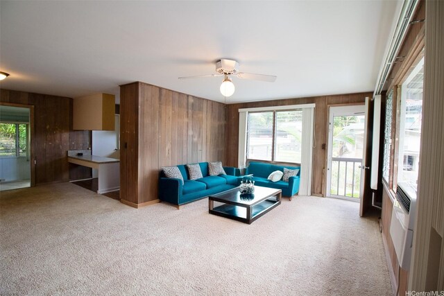 2410 Halenoho Pl, Honolulu, HI 96816 - living area with wood walls, light colored carpet, plenty of natural light, and a ceiling fan