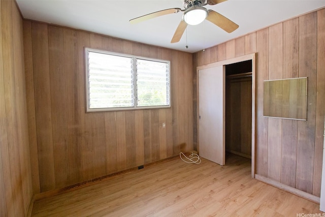 2410 Halenoho Pl, Honolulu, HI 96816 - unfurnished bedroom featuring wooden walls, light wood-style floors, a closet, and ceiling fan