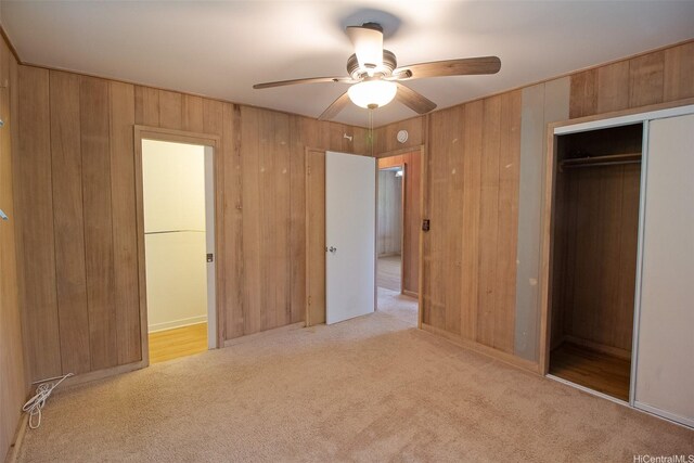 2410 Halenoho Pl, Honolulu, HI 96816 - unfurnished bedroom featuring carpet flooring, a closet, wood walls, and a ceiling fan