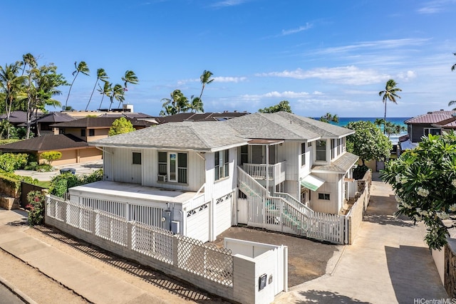 3153 Diamond Head Rd, Honolulu, HI 96815 - back of house with roof with shingles, a fenced front yard, an attached garage, and stairs