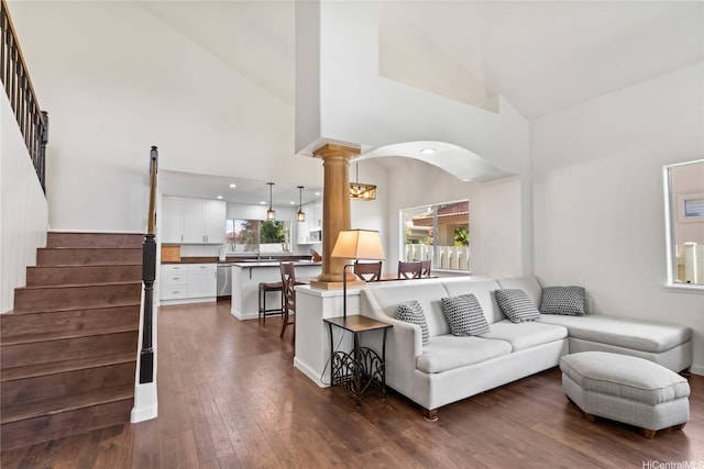 91-1186 Namahoe St, Kapolei, HI 96707 - living area with decorative columns, dark wood-type flooring, high vaulted ceiling, stairway, and arched walkways