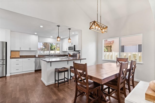 91-1186 Namahoe St, Kapolei, HI 96707 - dining space featuring dark wood-style flooring, recessed lighting, and high vaulted ceiling
