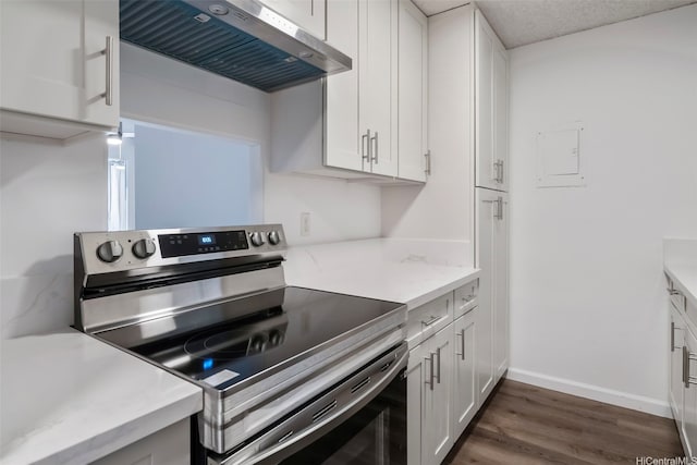 1215 Alexander St Unit 204, Honolulu, HI 96826 - kitchen featuring stainless steel range with electric cooktop, ventilation hood, white cabinets, dark wood finished floors, and light stone counters