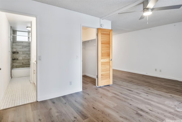1215 Alexander St Unit 204, Honolulu, HI 96826 - unfurnished bedroom featuring a walk in closet, light wood-style floors, and ensuite bath