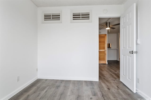 1215 Alexander St Unit 204, Honolulu, HI 96826 - spare room featuring wood finished floors, a ceiling fan, and a smoke detector