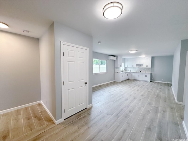 811 20th Ave, Honolulu, HI 96816 - unfurnished living room featuring a wall unit AC and light wood finished floors