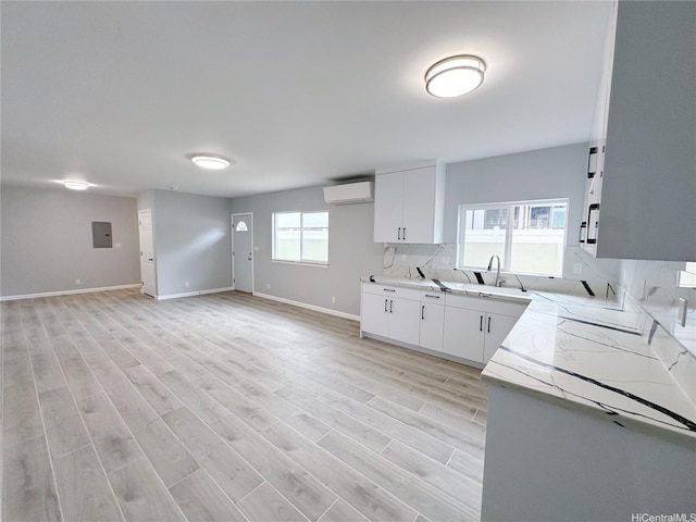 811 20th Ave, Honolulu, HI 96816 - kitchen featuring light countertops, open floor plan, backsplash, and light wood-style floors
