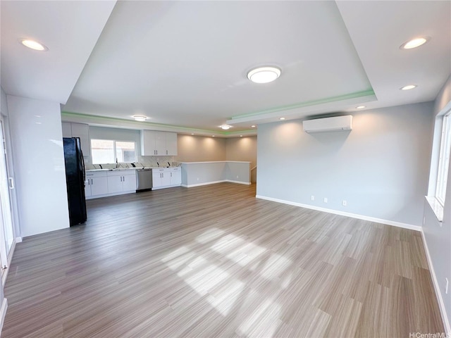 811 20th Ave, Honolulu, HI 96816 - unfurnished living room with a wall unit AC, light wood-style flooring, and recessed lighting