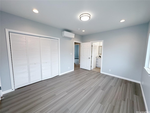 811 20th Ave, Honolulu, HI 96816 - unfurnished bedroom with a wall unit AC, a closet, wood finished floors, recessed lighting, and ensuite bath