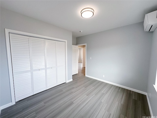 811 20th Ave, Honolulu, HI 96816 - unfurnished bedroom featuring wood finished floors, a closet, and a wall unit AC
