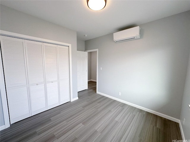 813 20th Ave, Honolulu, HI 96816 - unfurnished bedroom with a wall mounted AC, wood finished floors, and a closet