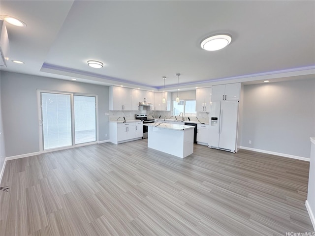 813 20th Ave, Honolulu, HI 96816 - kitchen with white refrigerator with ice dispenser, stainless steel electric range, light countertops, white cabinets, and recessed lighting