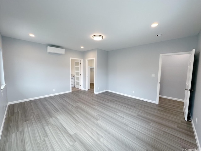813 20th Ave, Honolulu, HI 96816 - spare room with a wall unit AC, wood finished floors, and recessed lighting
