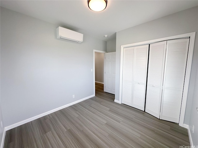 813 20th Ave, Honolulu, HI 96816 - unfurnished bedroom featuring a wall mounted AC, wood finished floors, and a closet
