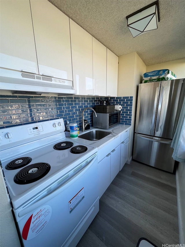 444 Niu St Unit 2906, Honolulu, HI 96815 - kitchen with stainless steel appliances, under cabinet range hood, white cabinets, light countertops, and backsplash