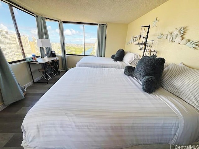 444 Niu St Unit 2906, Honolulu, HI 96815 - bedroom featuring dark wood finished floors and a textured ceiling