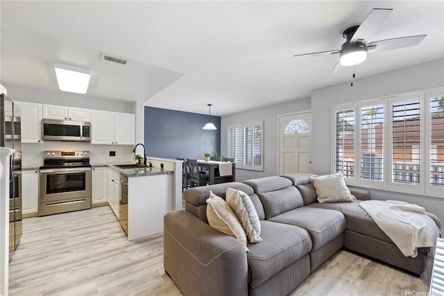 91-1031 Kaimalie St Unit 4M4, Ewa Beach, HI 96706 - living room with light wood-style floors and ceiling fan