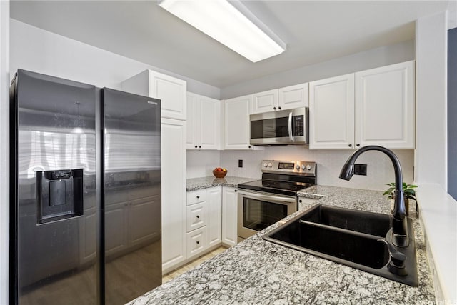 91-1031 Kaimalie St Unit 4M4, Ewa Beach, HI 96706 - kitchen featuring stainless steel appliances, white cabinets, light stone countertops, and light wood-style flooring