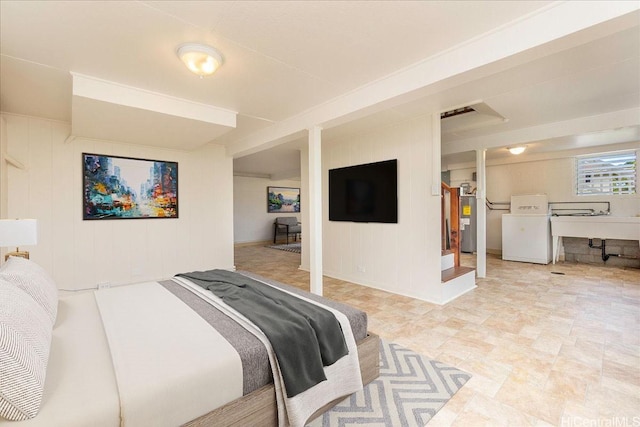 101 Kawananakoa Pl, Honolulu, HI 96817 - bedroom featuring washer / clothes dryer, water heater, wooden walls, a desk, and light stone finish flooring